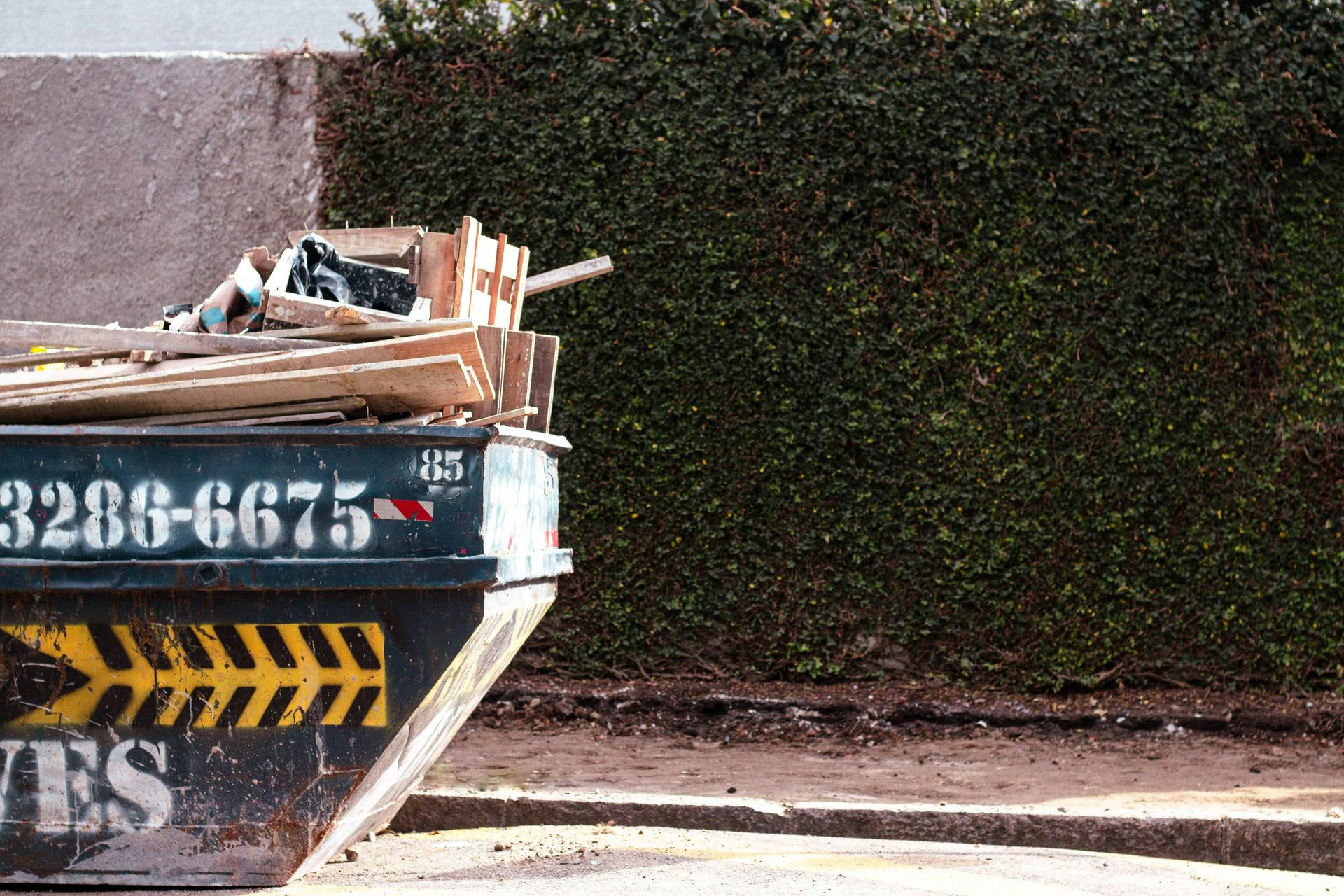 a pile of wood sitting on the side of a road